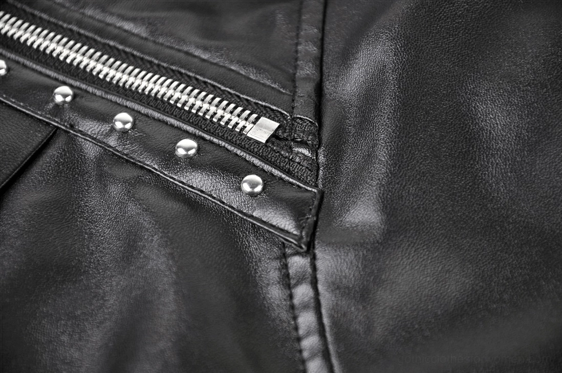 Detailed close-up of black gothic skirt metal zipper, rivets, and stitched seam construction