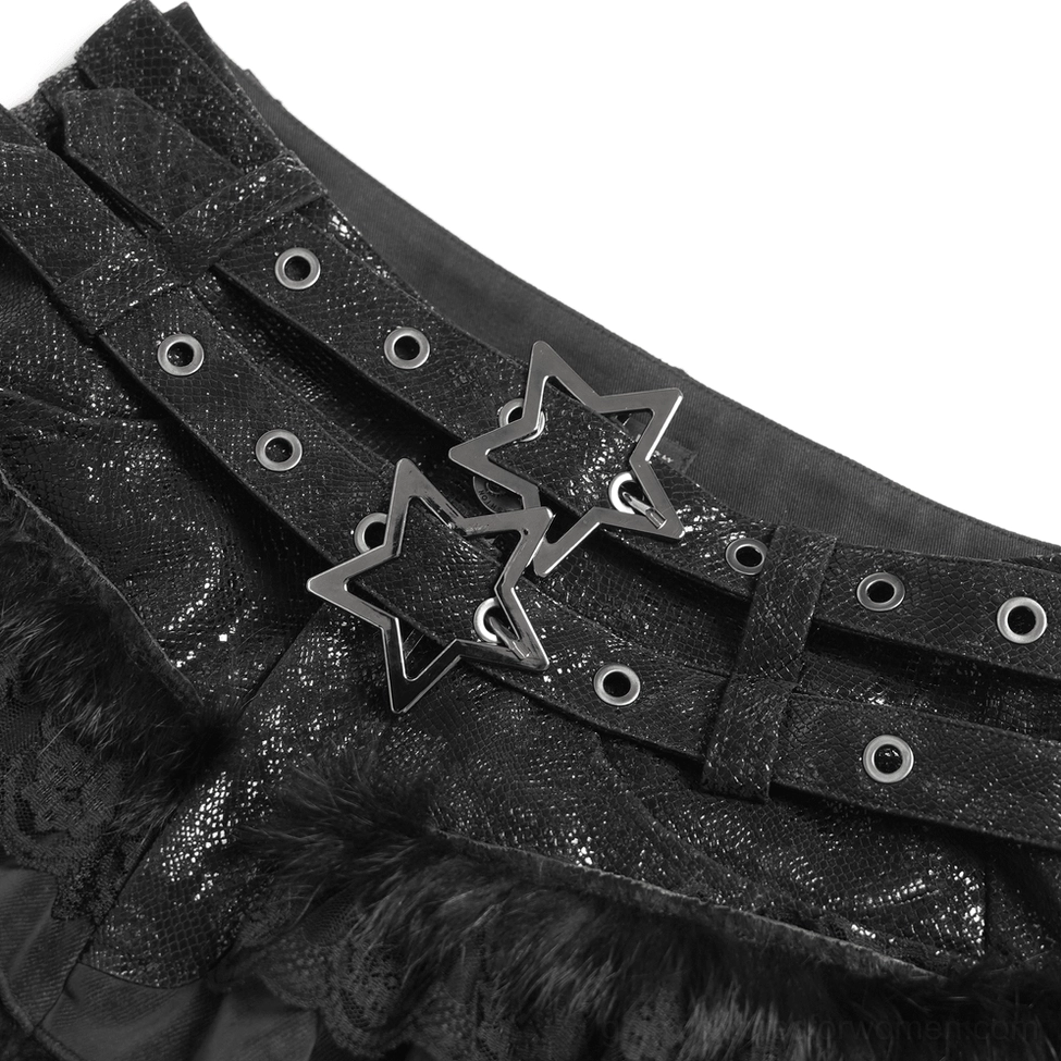 Close-up detail of black gothic skort showing dual star buckles, metal eyelets, and floral lace ruffles