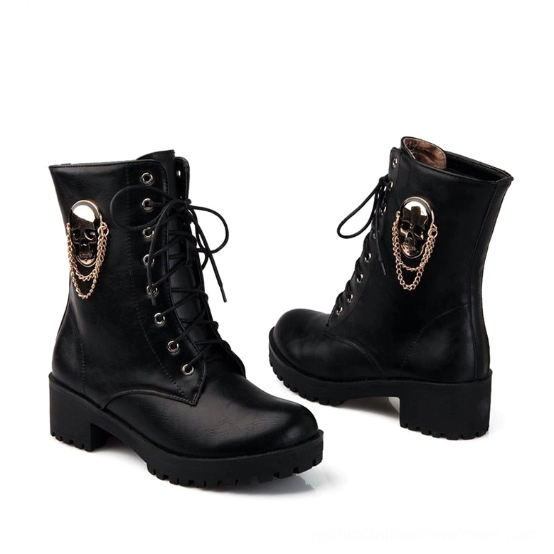Side profile of black lace-up platform boots featuring antique gold skull decoration and aggressive lug rubber sole
