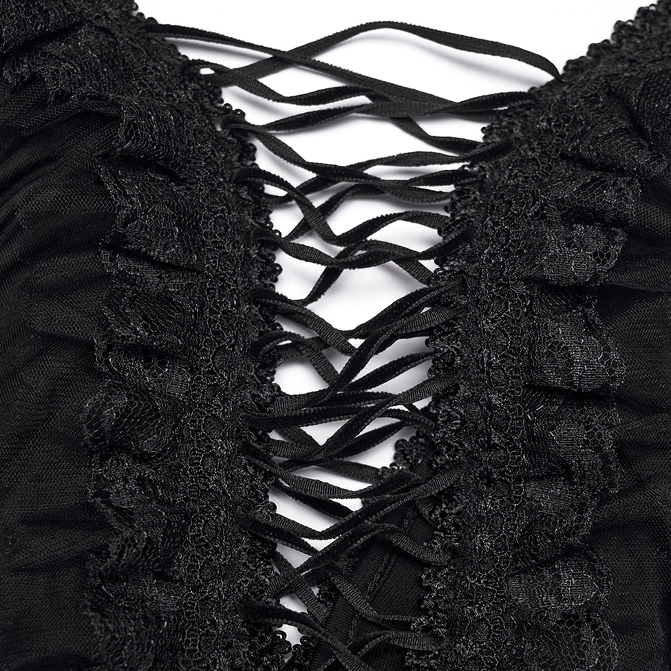 Close-up detail of black ruffled lace-up trim and adjustable straps on gothic slip dress