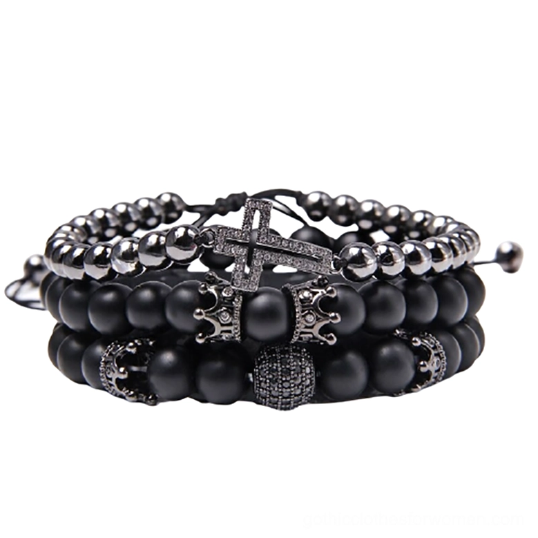 Black gothic multi-strand bracelet set with volcanic stone beads, cross pendant and ornate charms, front flat view on white background