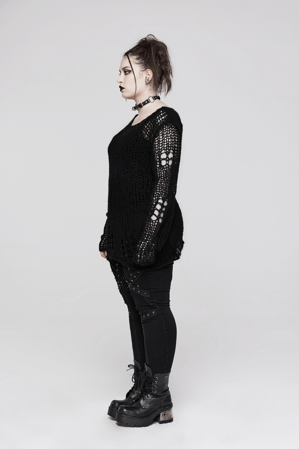 Black distressed gothic sweater fabric showing crocheted mesh weave, fiber texture, and semi-sheer material properties