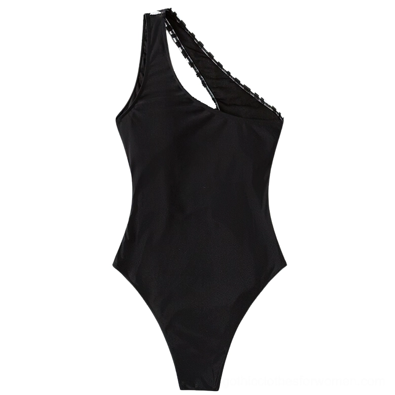 Back flat lay of black one-piece gothic swimsuit showing scalloped trim and high-cut silhouette