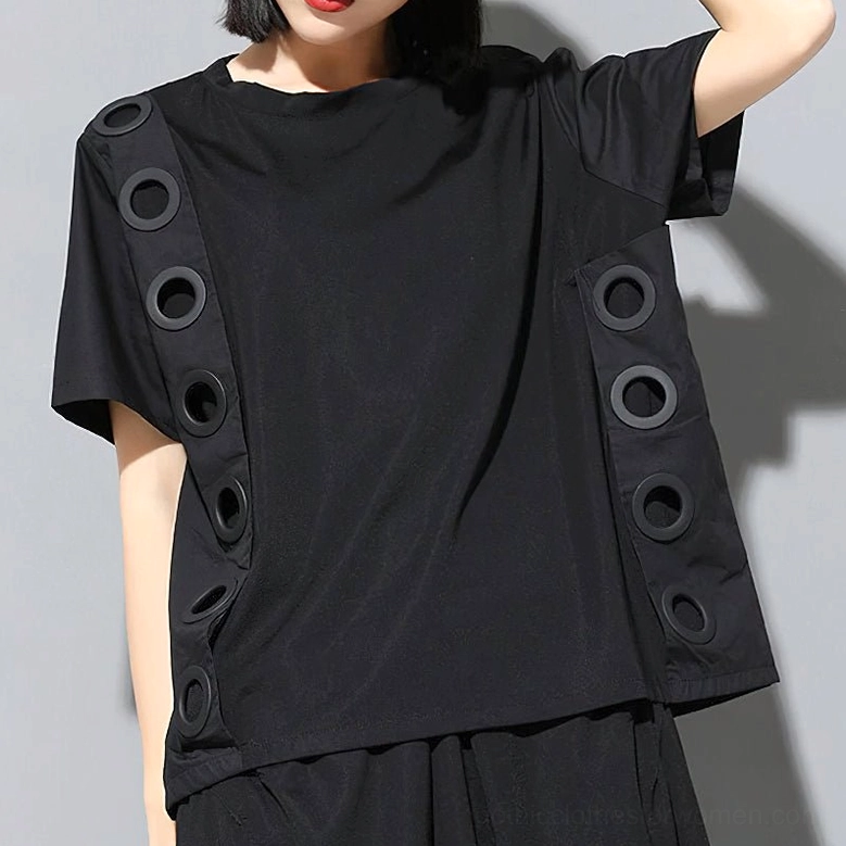 Women's black gothic t-shirt front three-quarter view showing crew neck and metal grommet side panels in light studio setting