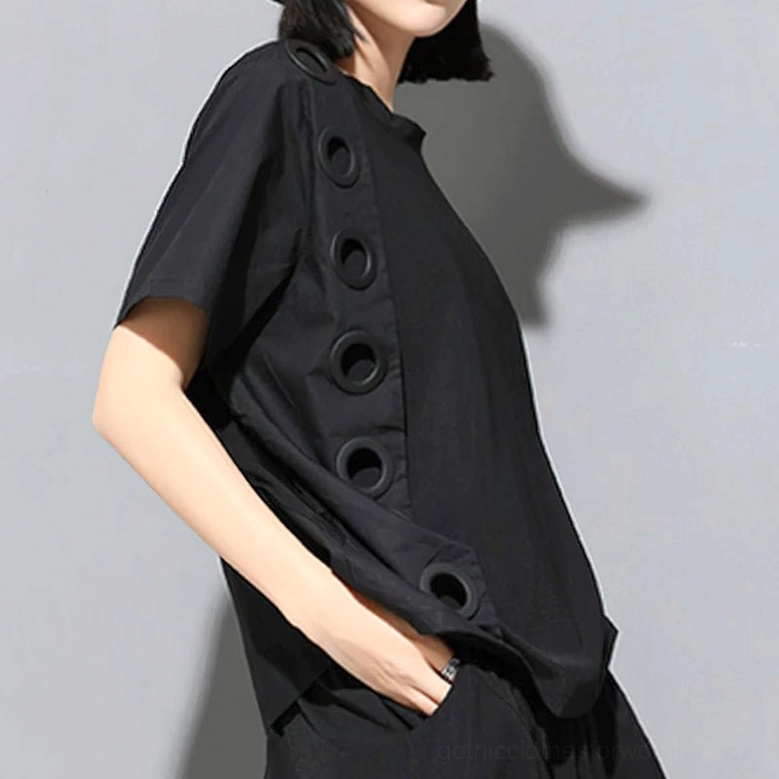 Black relaxed-fit gothic short-sleeve top side profile view displaying loose silhouette and grommet-decorated side panels