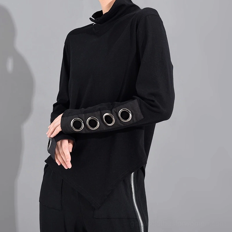 Black asymmetrical gothic top with metal cuff grommets, left side view on model highlighting asymmetric hem design