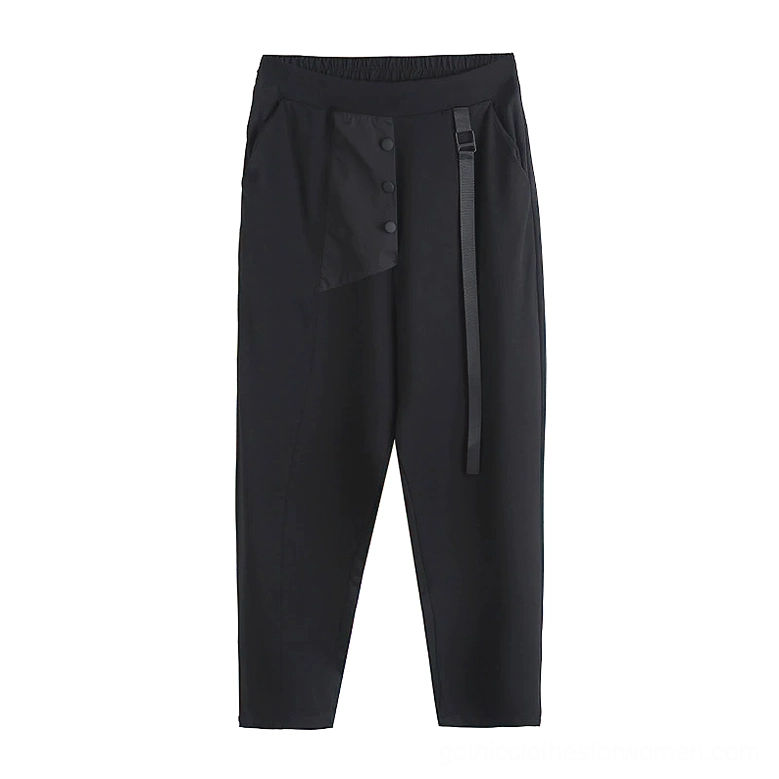 Flat lay front view of black alternative women's harem pants displaying asymmetric buttoned pocket design and side ribbon trim