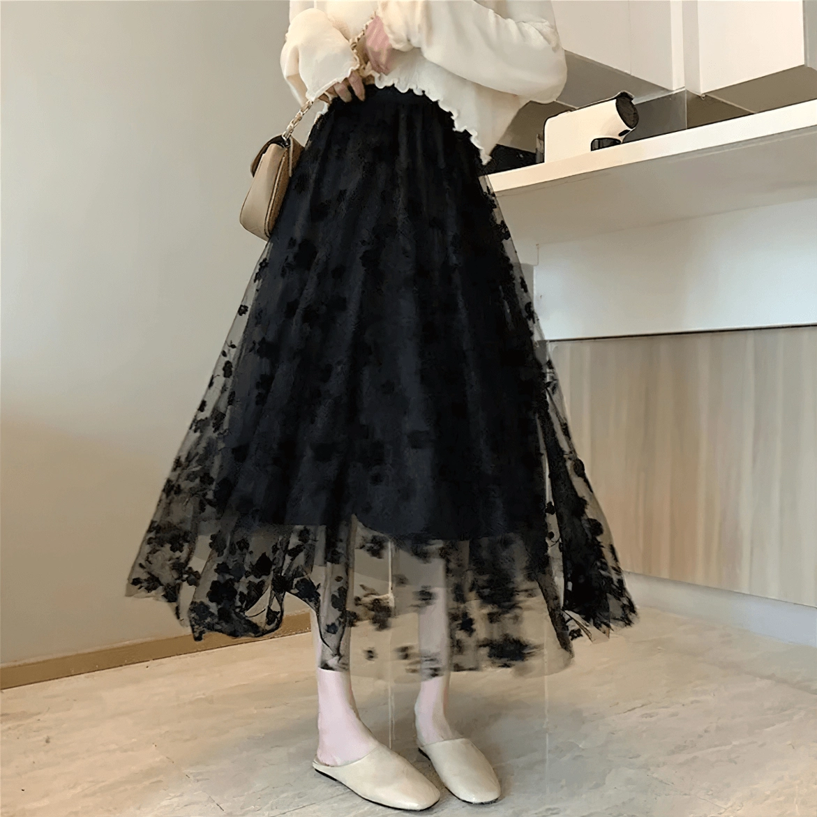 Black gothic tulle midi skirt sheer overlay, ankle-length cut, white top styling, indoor utility area setting