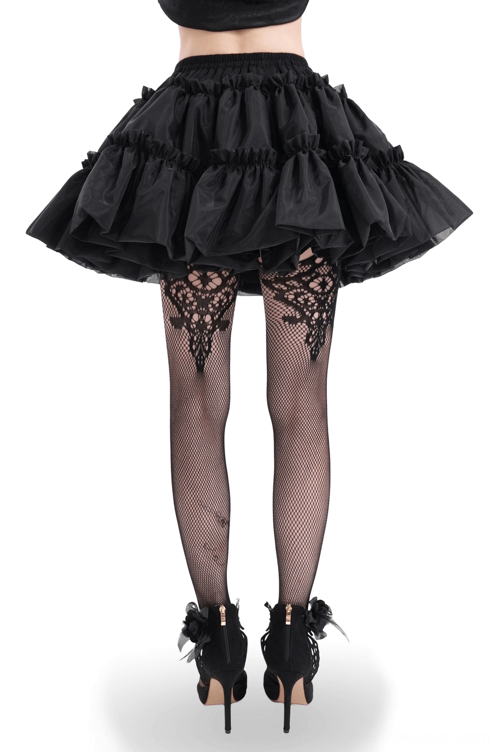 Back view of black gothic ruffled tulle skirt featuring layered tiered construction and elastic waistband, worn with lace thigh-high stockings