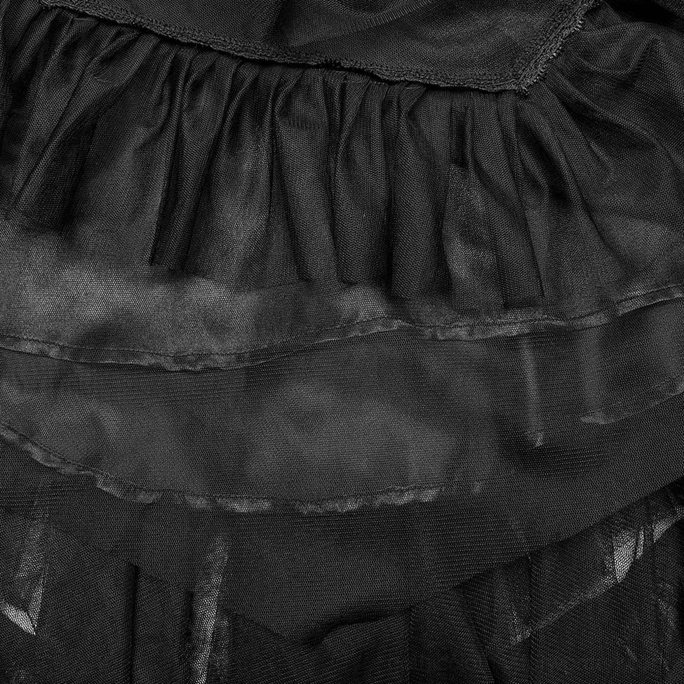Black gothic tiered tulle ruffle skirt detail showing peach embroidered patch accent and mesh layers