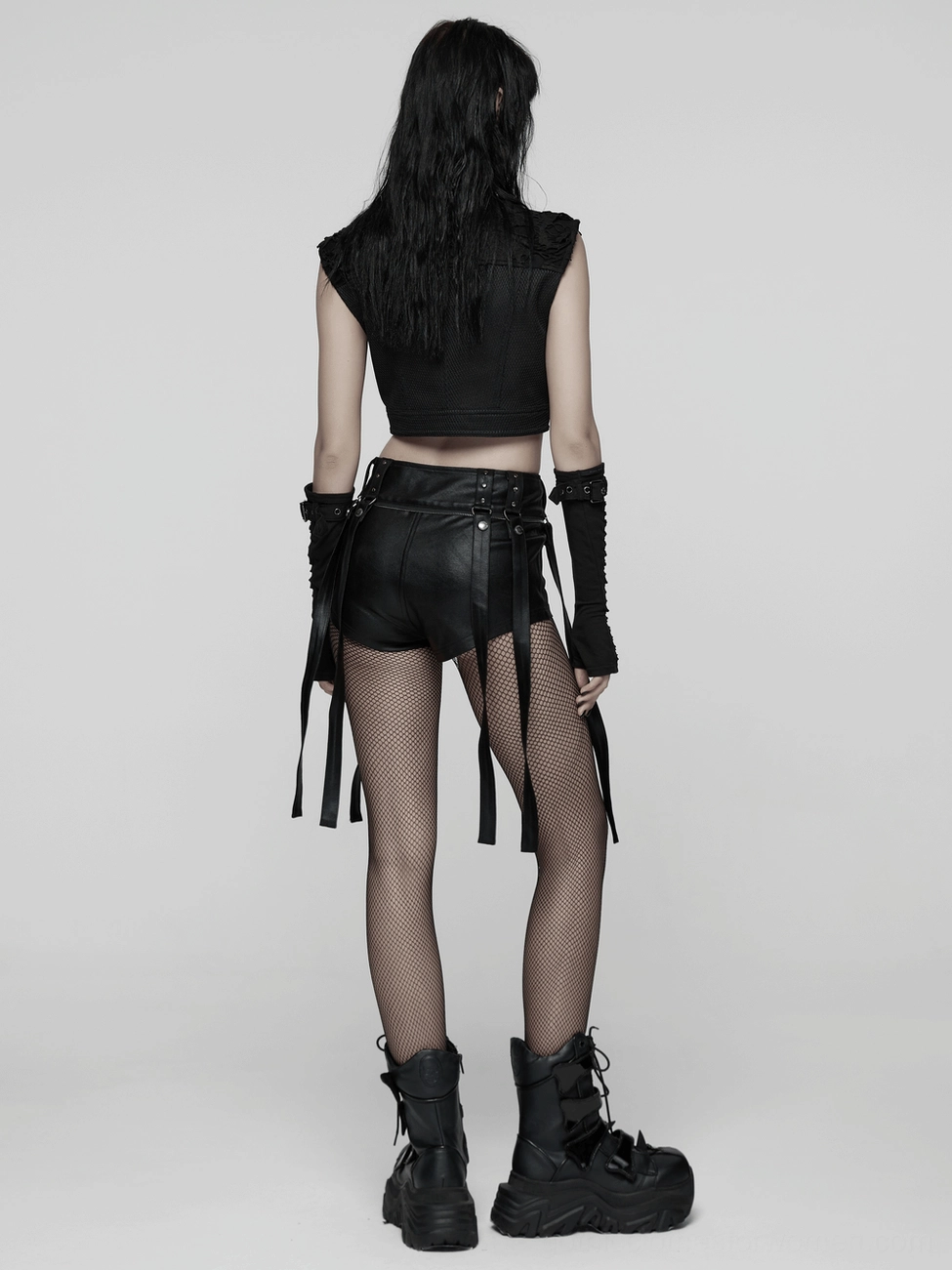 Model wearing black gothic layered tulle skirt-shorts with detachable elements styled for alternative fashion