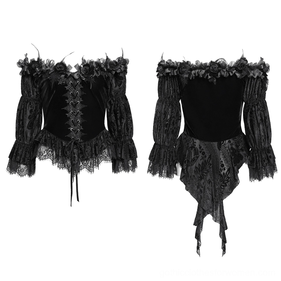 Flat lay top-down view of black gothic velvet blouse displaying lace trims, lace-up front closure, and ruffled hem details