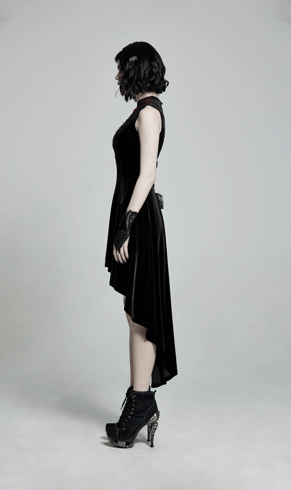 Black gothic velvet high-low dress showing asymmetrical hemline and fitted body silhouette