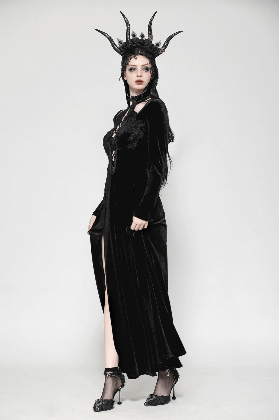 Front view of black gothic velvet dress with model, emphasizing front lace-up corset design and neckline details
