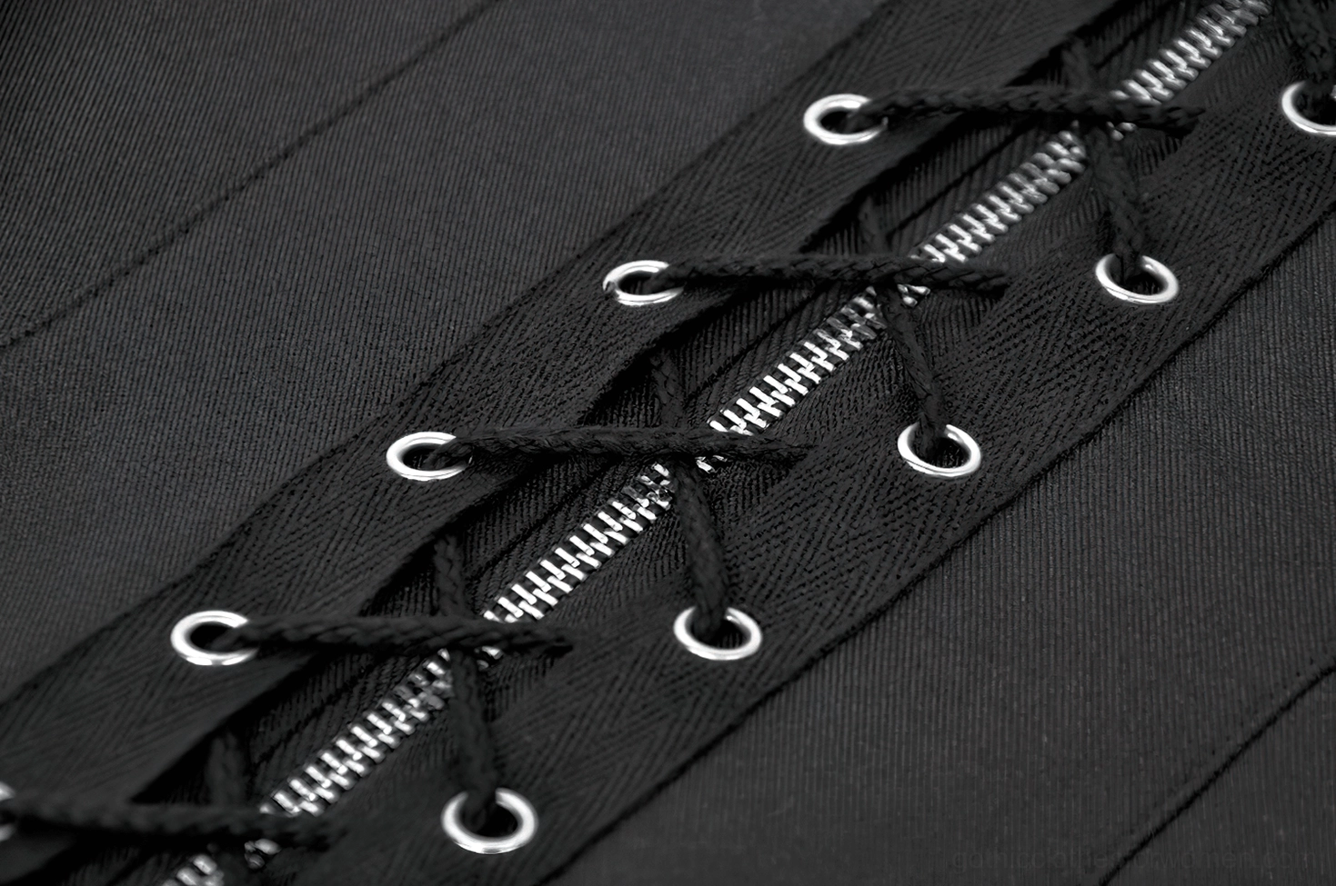 Black gothic waistcoat styled with fishnet and band merchandise aesthetic