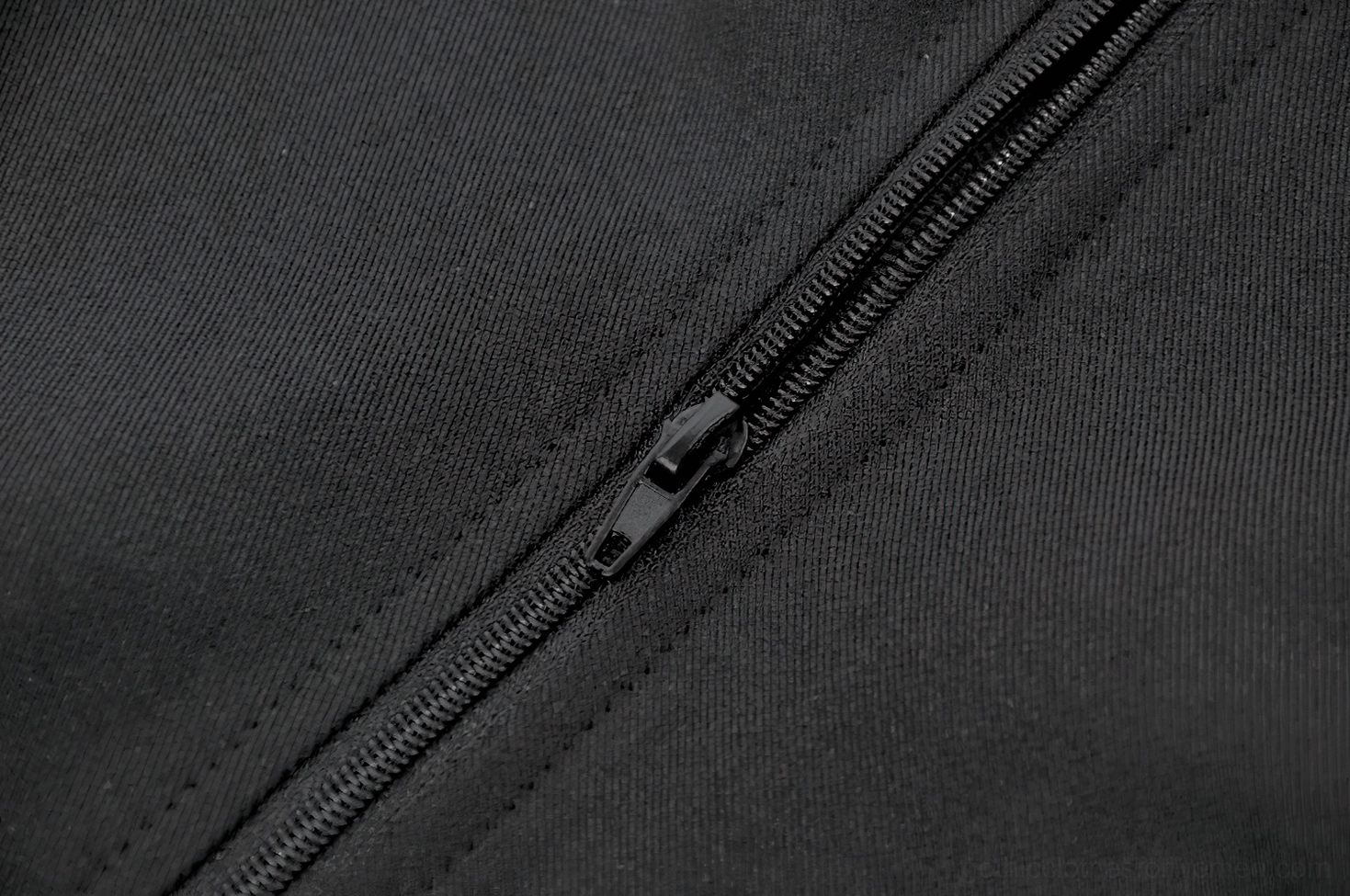 Black studded gothic waistcoat collar and front zipper hardware detail shot