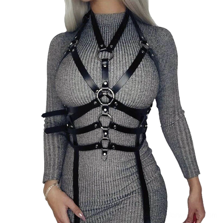 Black PU leather arm and chest harness over gray dress, arm strap configuration with metal buckles