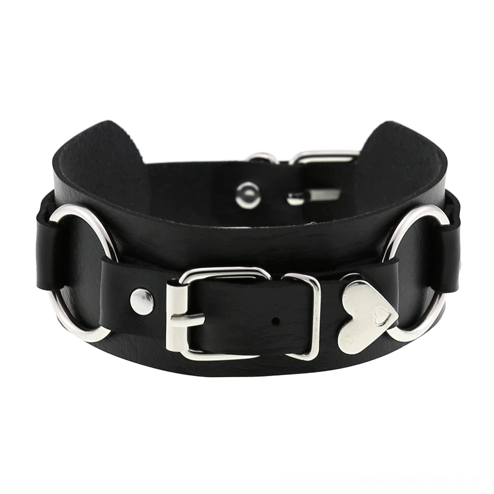 Black leather choker with silver D-ring buckles and heart-shaped pendant, flat lay front close-up on white background