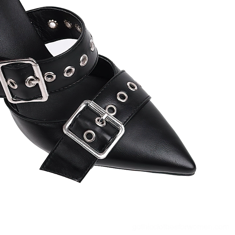 Close-up detail of black stiletto heel with metal buckle grommets and leather eyelet straps, gothic hardware design