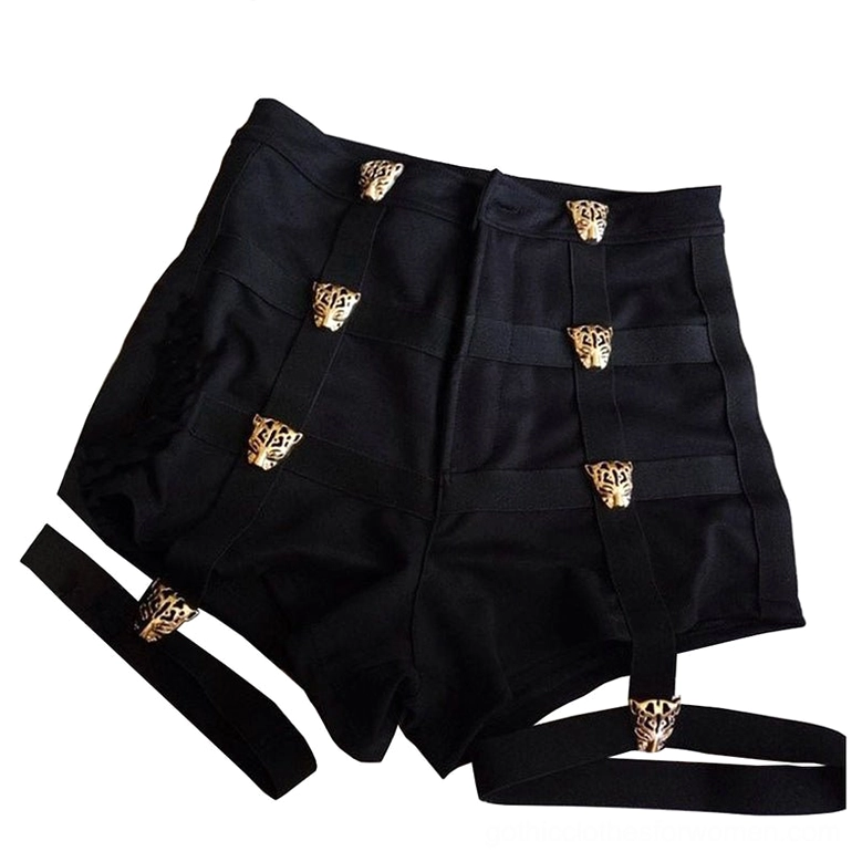 Black high-waist shorts flat lay overhead view displaying gold leopard buttons and dual thigh straps