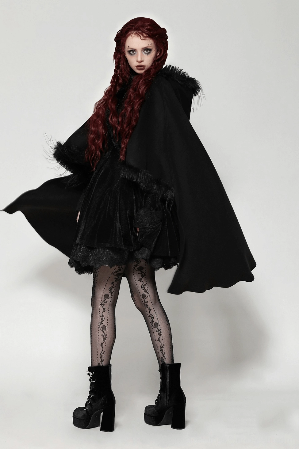 Gothic black hooded cape showcasing dramatic silhouette and faux fur hood detail