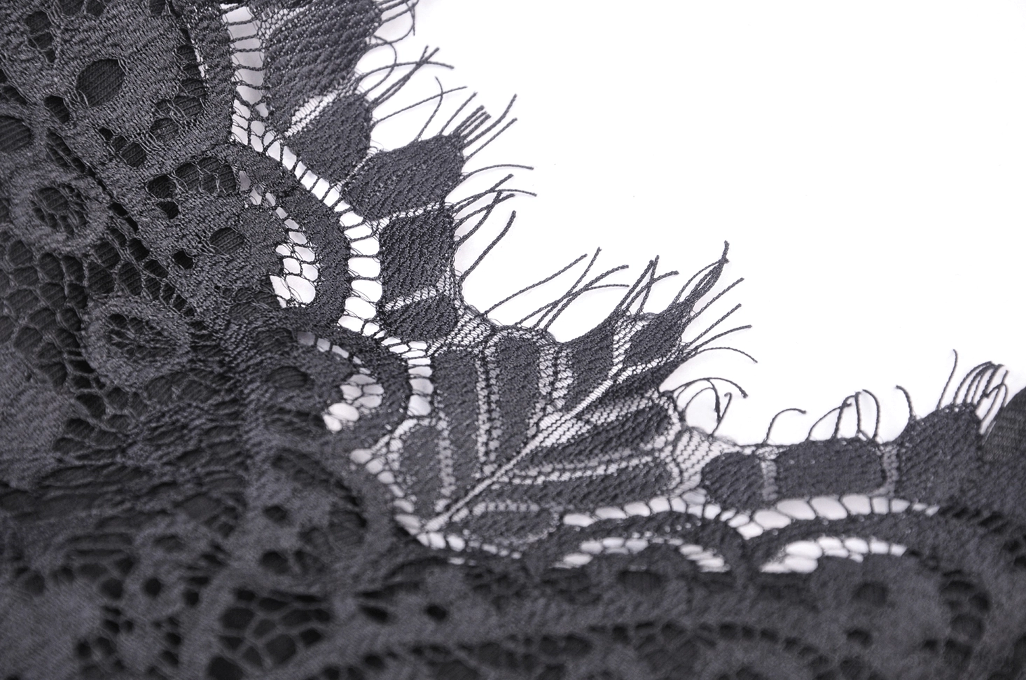 Detailed close-up of black eyelash lace trim with fringed edge finish, showcasing delicate lace quality and trim craftsmanship