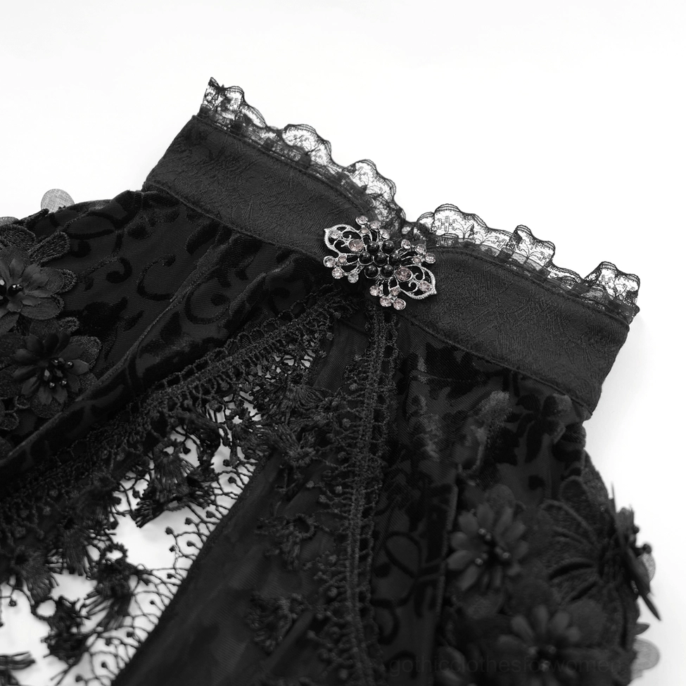 Close-up detail of black lace bolero collar featuring velvet stand collar with lace ruffle and decorative gothic brooch accent