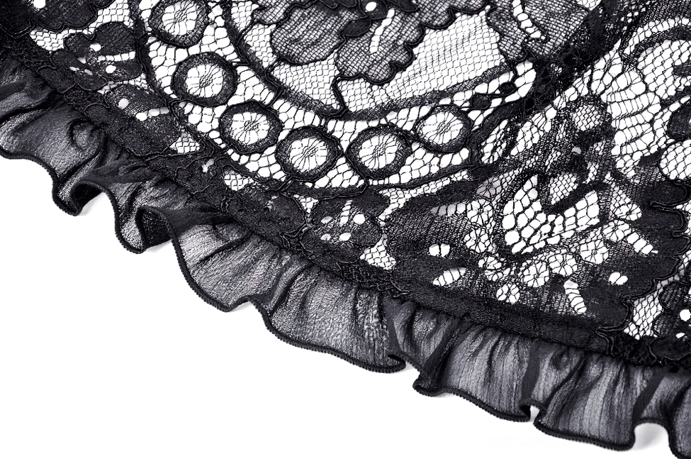 Detailed view of black lace cape showcasing mesh-based fabric with delicate floral motifs and texture