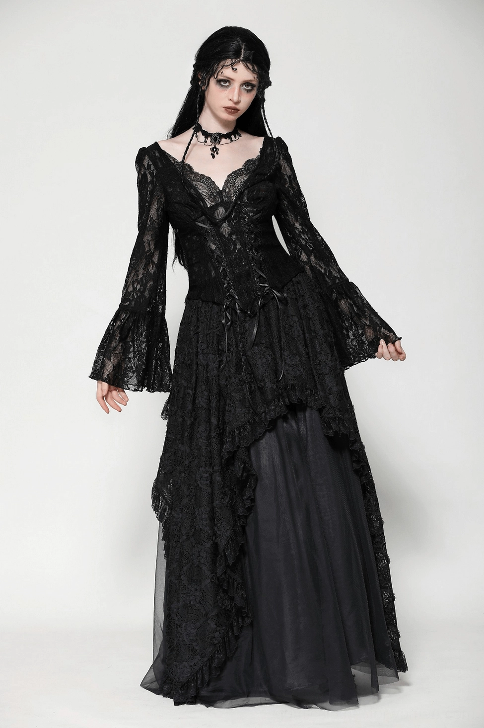 Full-body styling of black lace corset bell sleeve top demonstrating gothic fashion aesthetic