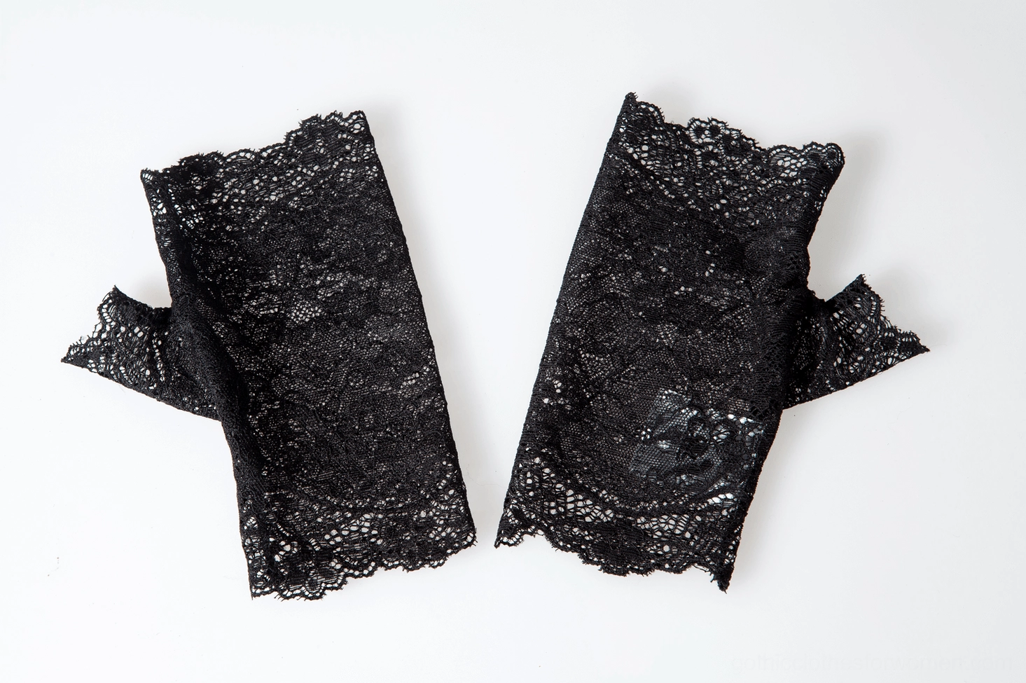 Side close-up view of single black lace fingerless glove on female hand, showing sheer lace texture and scalloped cuff design