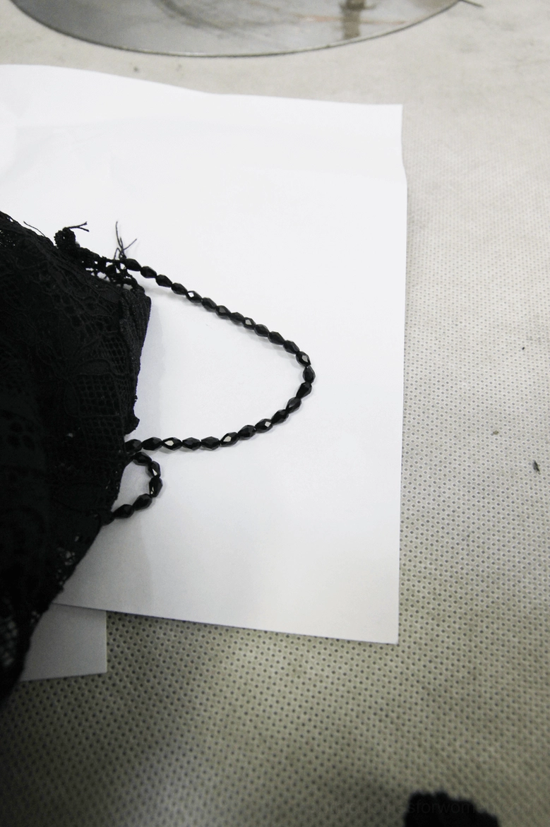 Black lace flare pants accessory detail – complementary braided strap and lace coordination