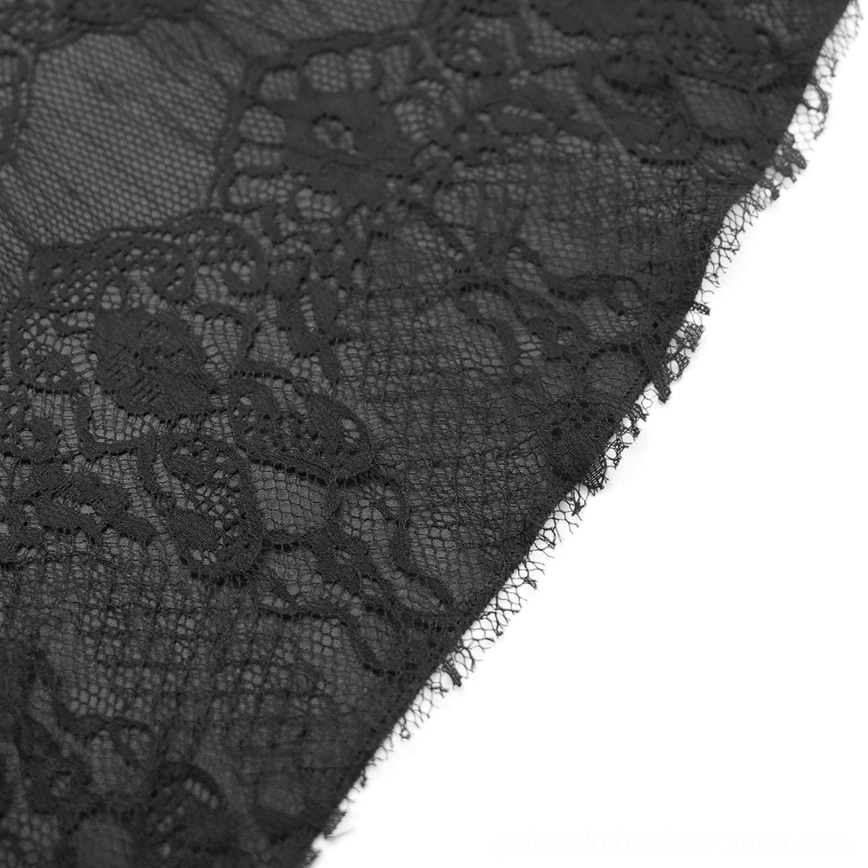 Black lace fabric texture detail showing intricate floral lace pattern with frayed raw edge and sheer mesh composition