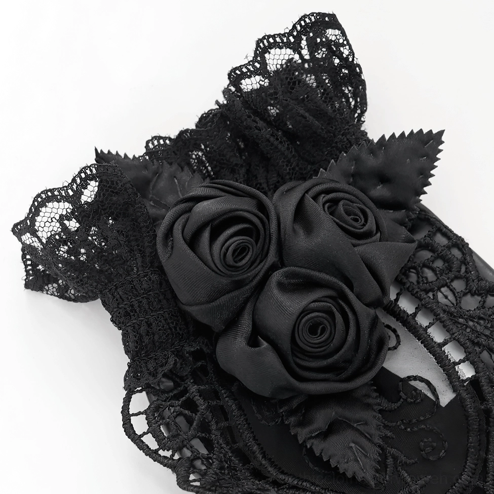 Black lace gothic gloves close-up showing multiple fabric roses and ruffled lace cuff construction