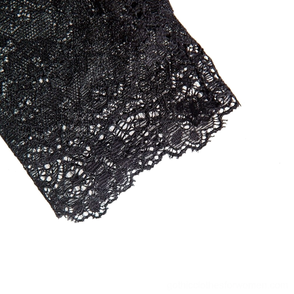Detailed macro view of black lace fingerless gloves fabric showing delicate lace texture and scalloped edge construction