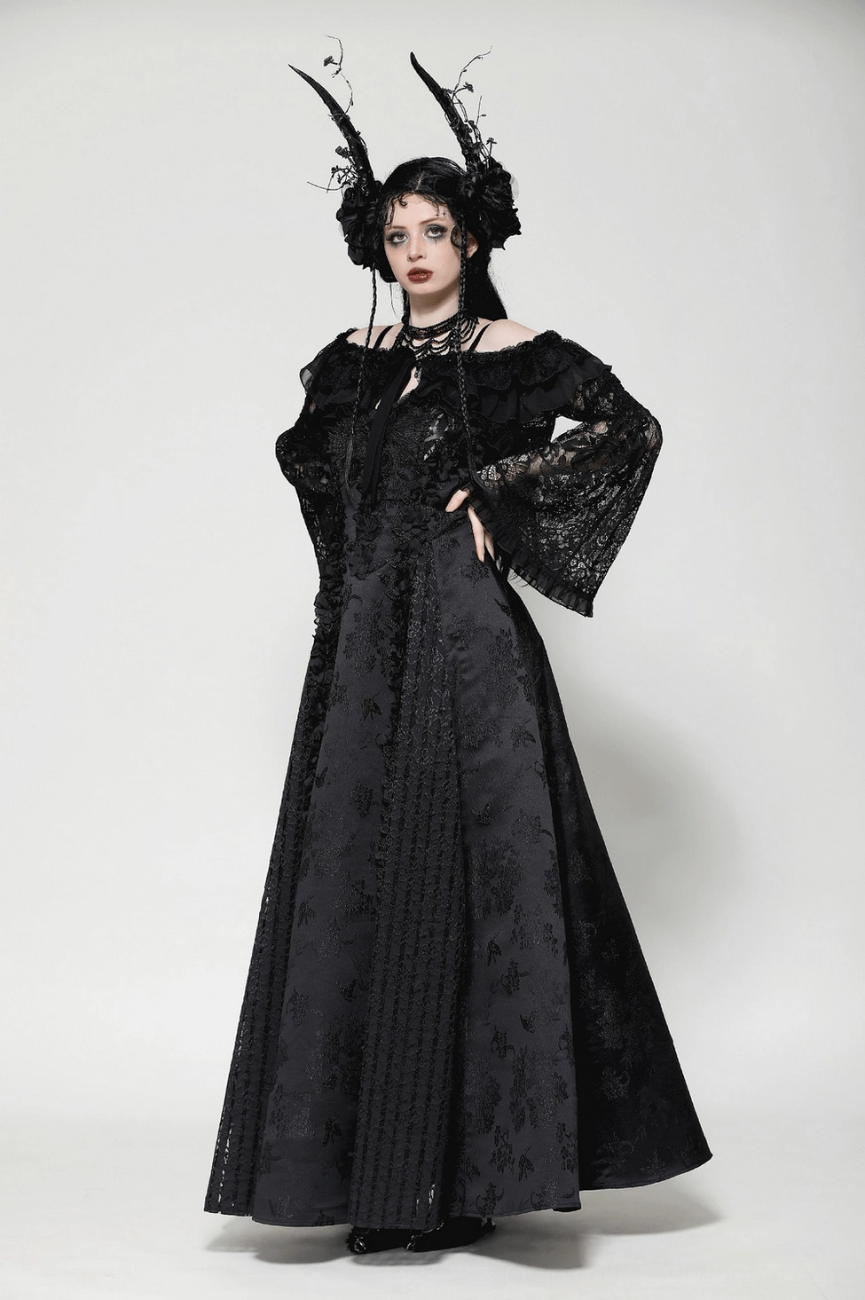Black lace gothic off-shoulder cape photographed from side angle highlighting bell sleeve silhouette
