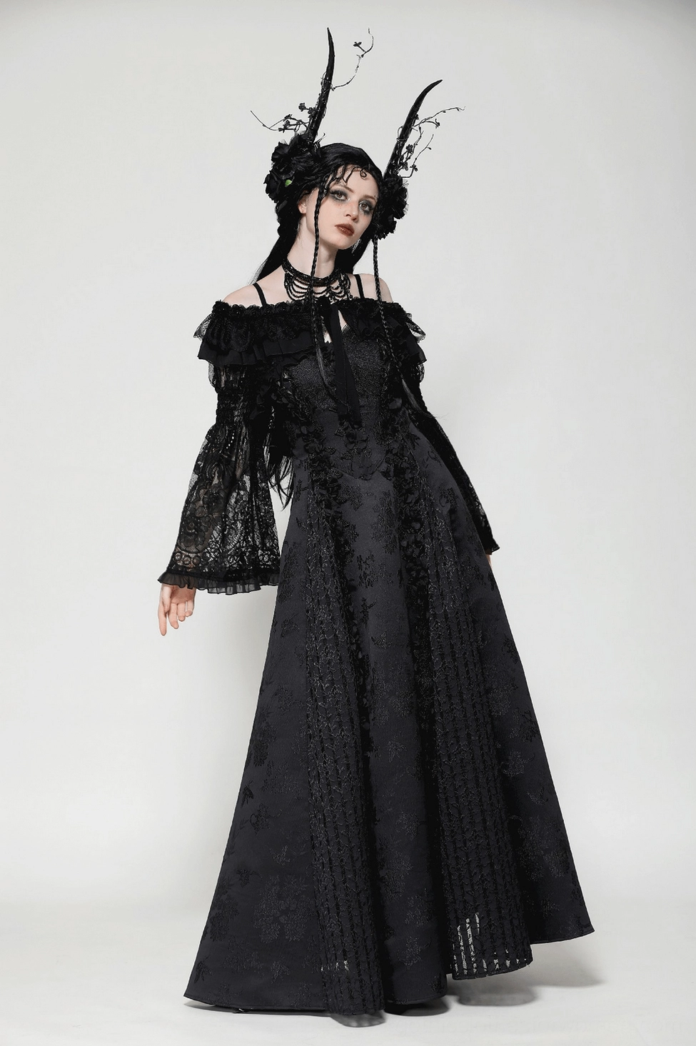 Black lace gothic cape detail showing tie-back closure system and ruffled shoulder construction