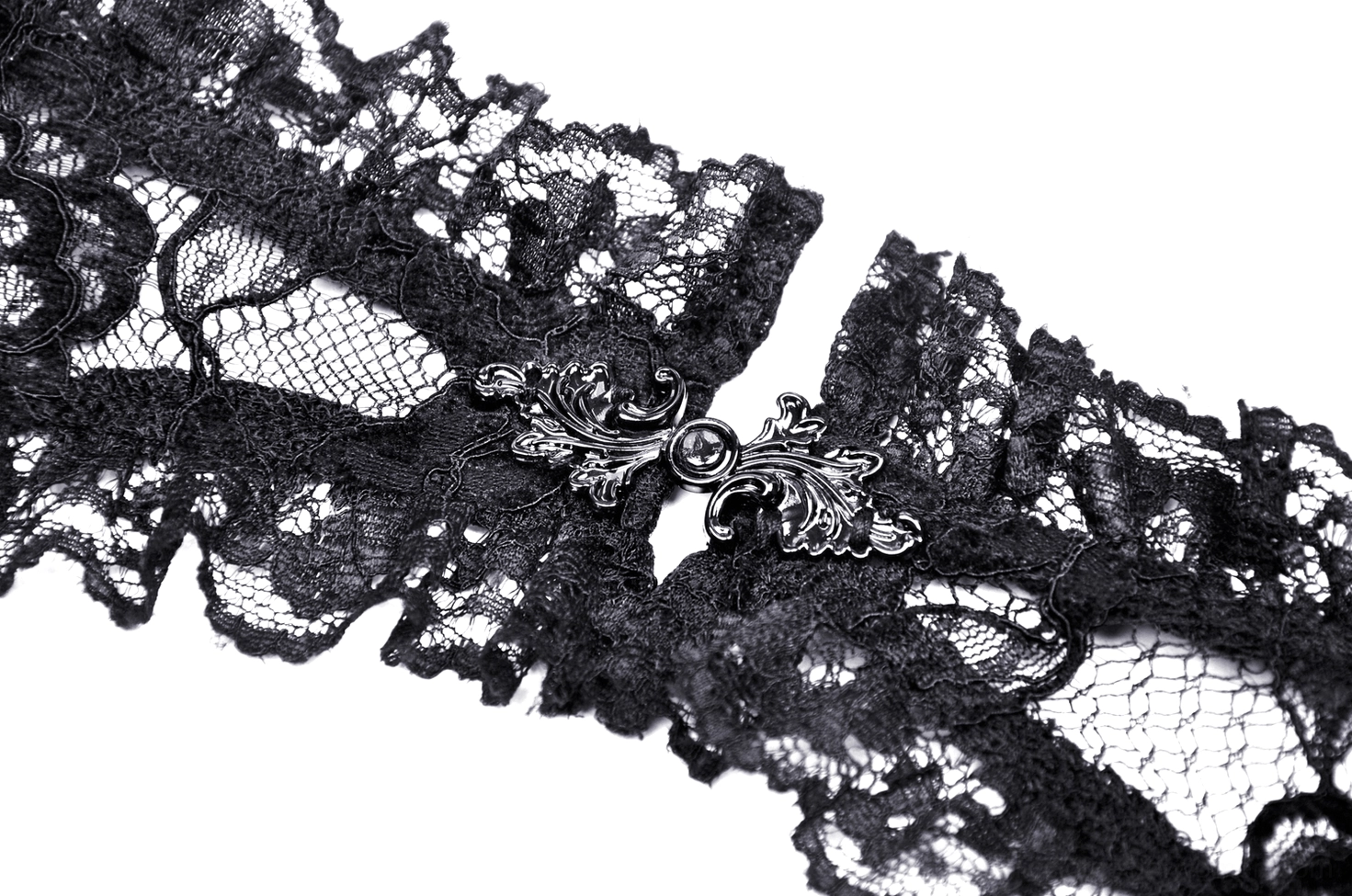 Black lace choker with ornate vintage metal buckle ornament, close-up flat lay featuring floral lace pattern