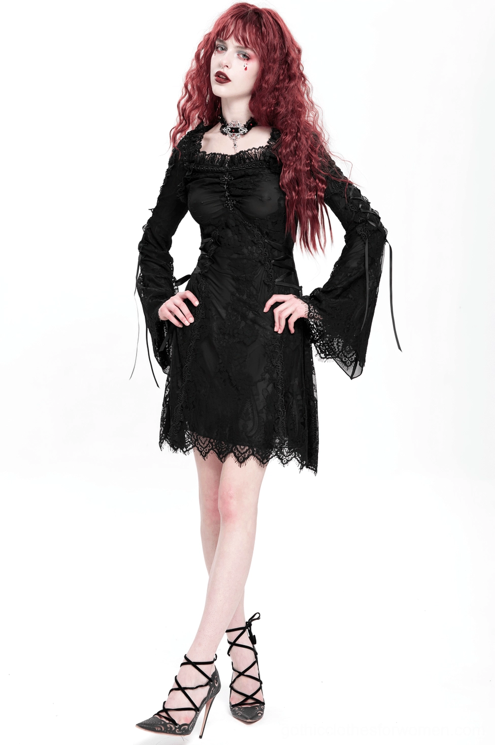 Black lace gothic mini dress on model showing elegant bell sleeves and romantic lace design