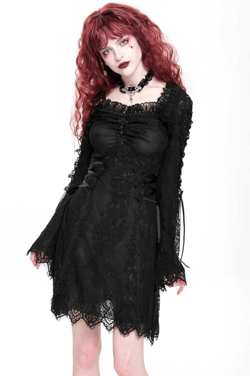 Black gothic lace mini dress showing intricate lace patterns and scalloped hemline edge