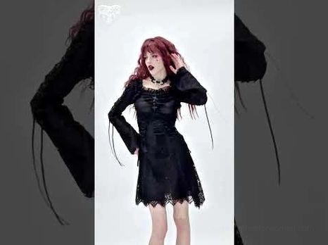 Side view of black lace gothic mini dress on model showcasing drawstring bell sleeves and lace overlay
