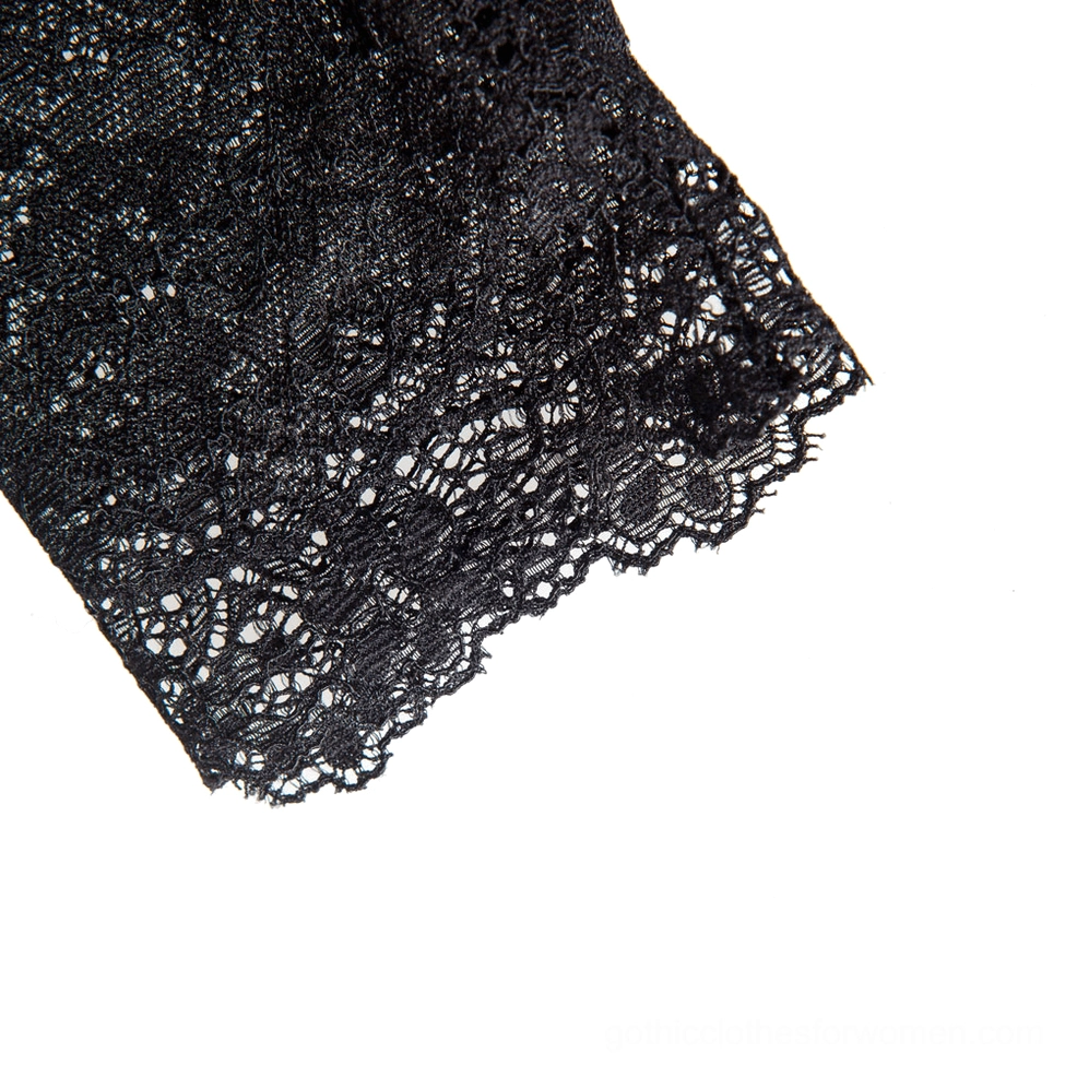 Flat lay close-up of black lace fabric swatch highlighting delicate scalloped hem and gothic lace craftsmanship