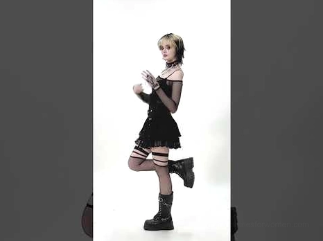 Black tiered lace gothic mini skirt styled with combat boots and fishnet stockings