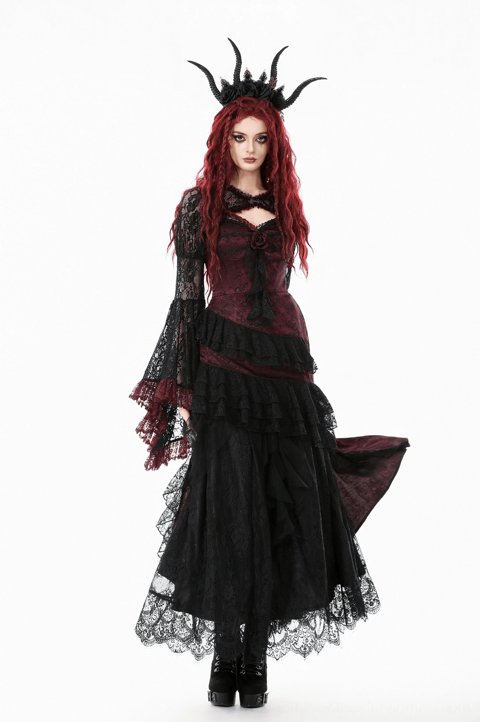 Flat lay of black lace shrug showing full silhouette with bell sleeves and wine-red ruffled details
