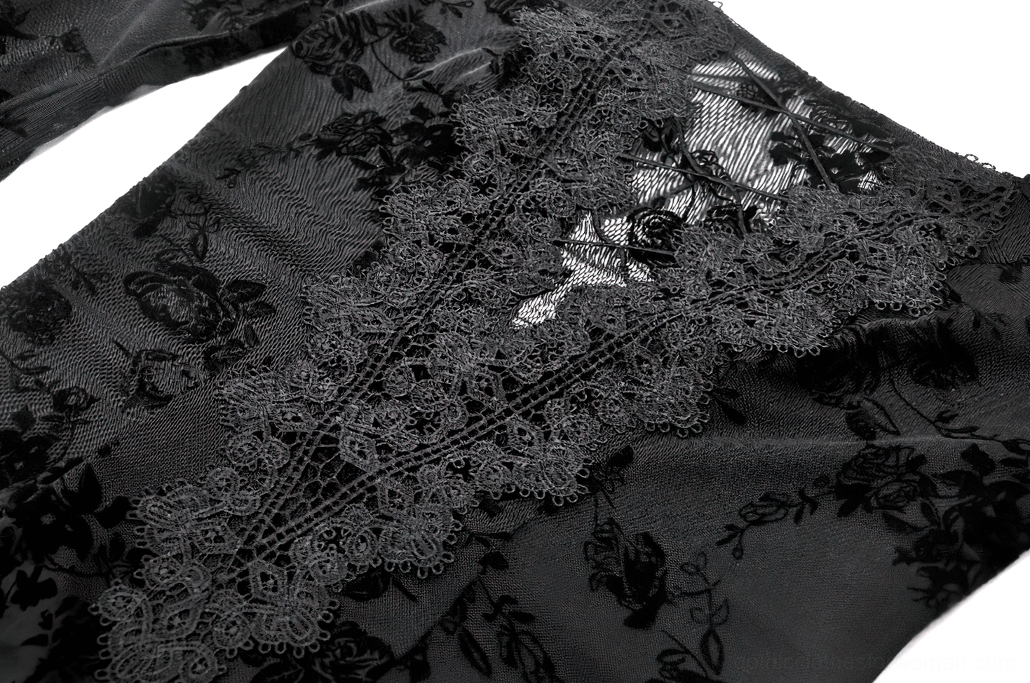 Close-up of intricate floral lace pattern with scalloped edge trim detail
