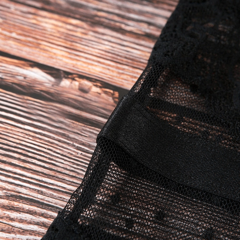 Black lace jumpsuit detail view emphasizing deep V-neckline, sheer lace overlay, and structured design