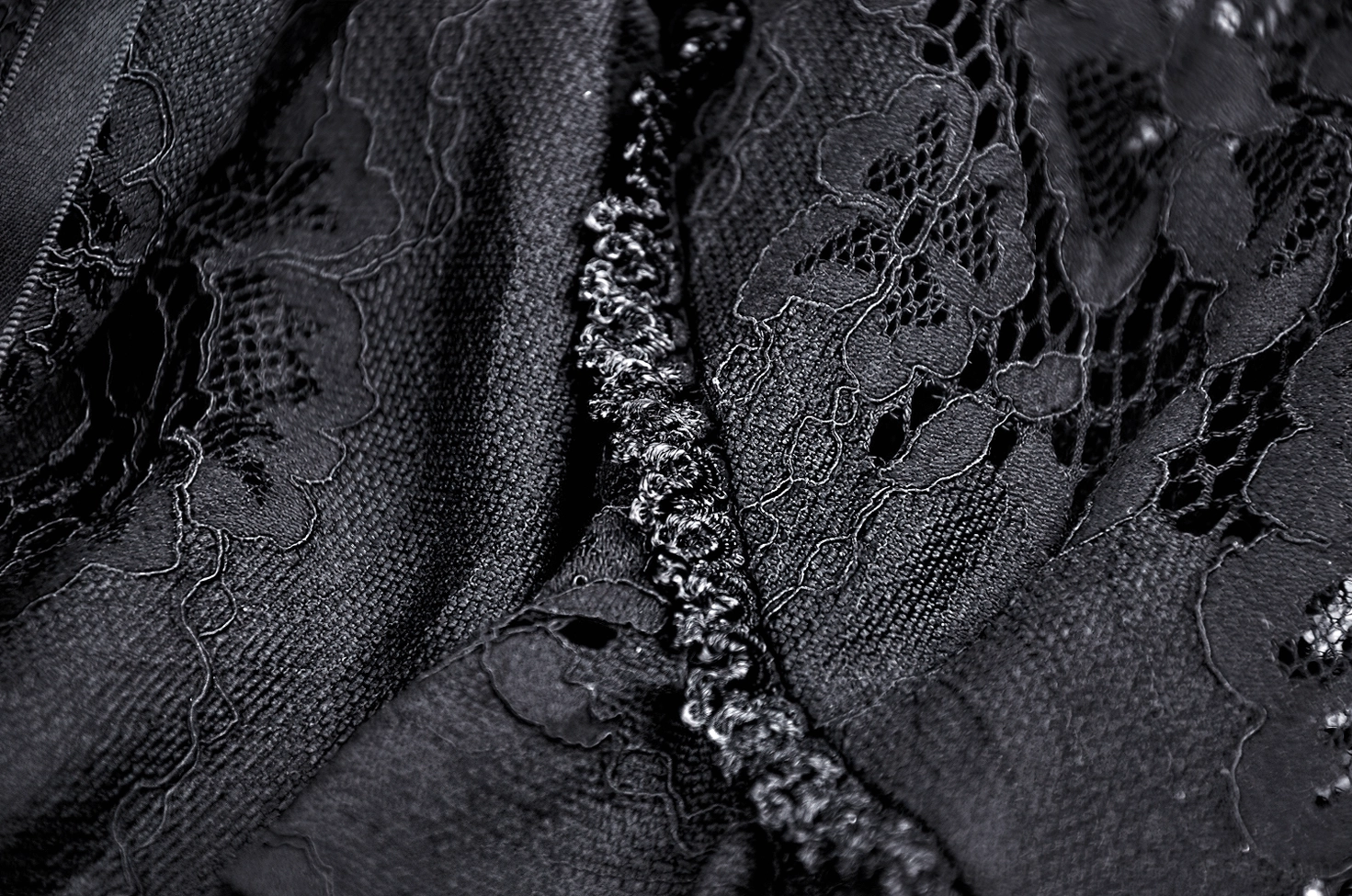 Close-up macro shot of beaded chain trim and black lace construction detail on gothic mermaid skirt hem