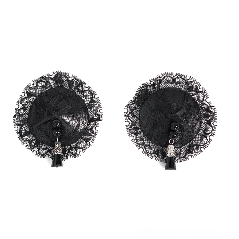 Pair of black floral lace nipple covers with ruffled edges and pearl tassel decoration flat lay