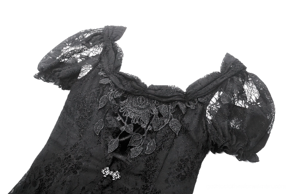 Close-up of black lace puff sleeve with floral neckline trim and decorative metal buttons