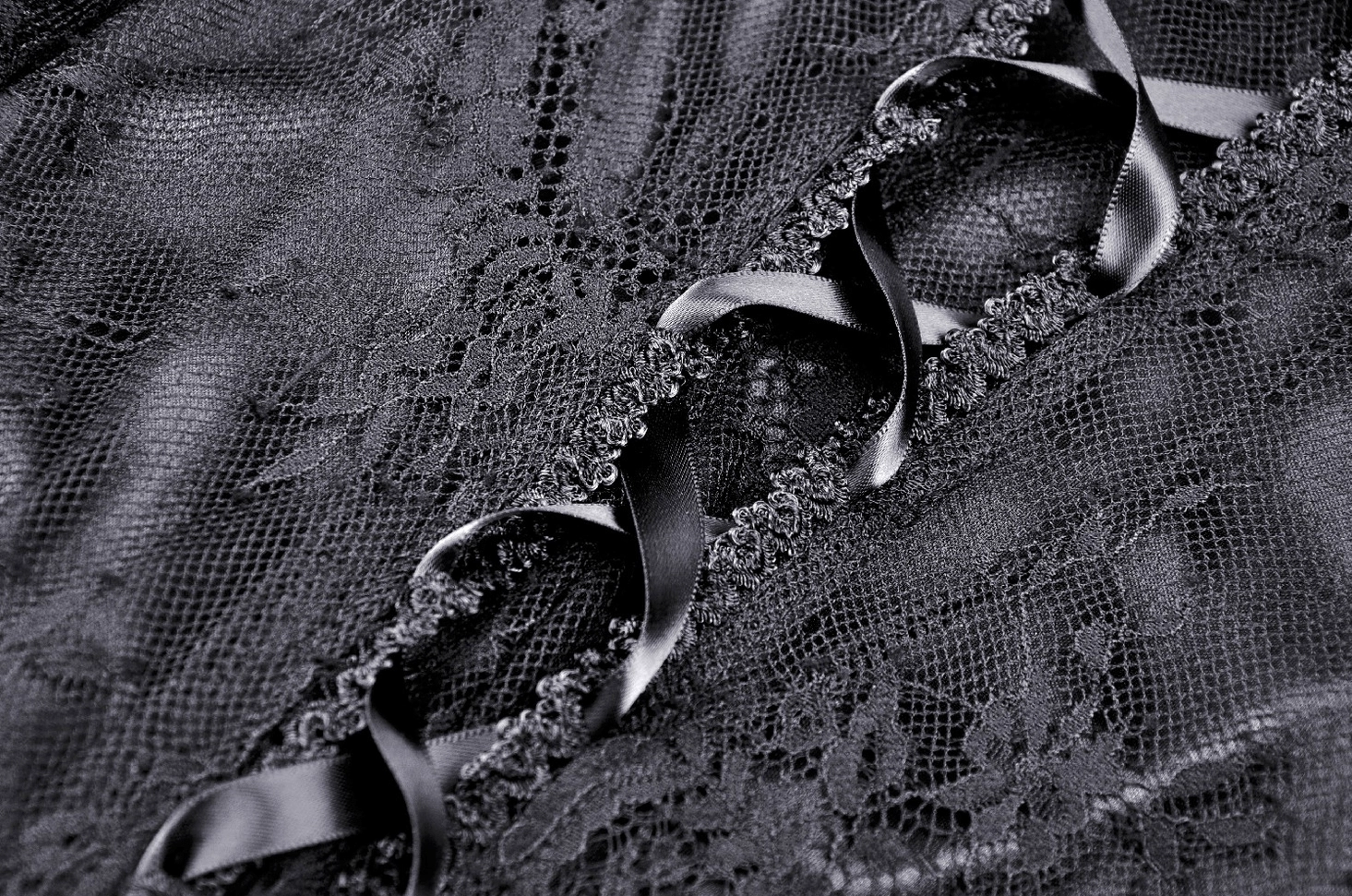 Detail shot of ribbon lace-up closure on black mesh lace gothic evening dress