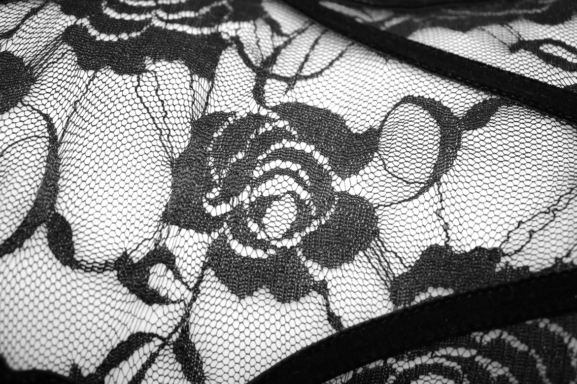 Black sheer lace fabric with rose embroidery pattern close-up showing intricate floral design